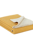 Kuscheldecke aus Wolle in MISTED YELLOW