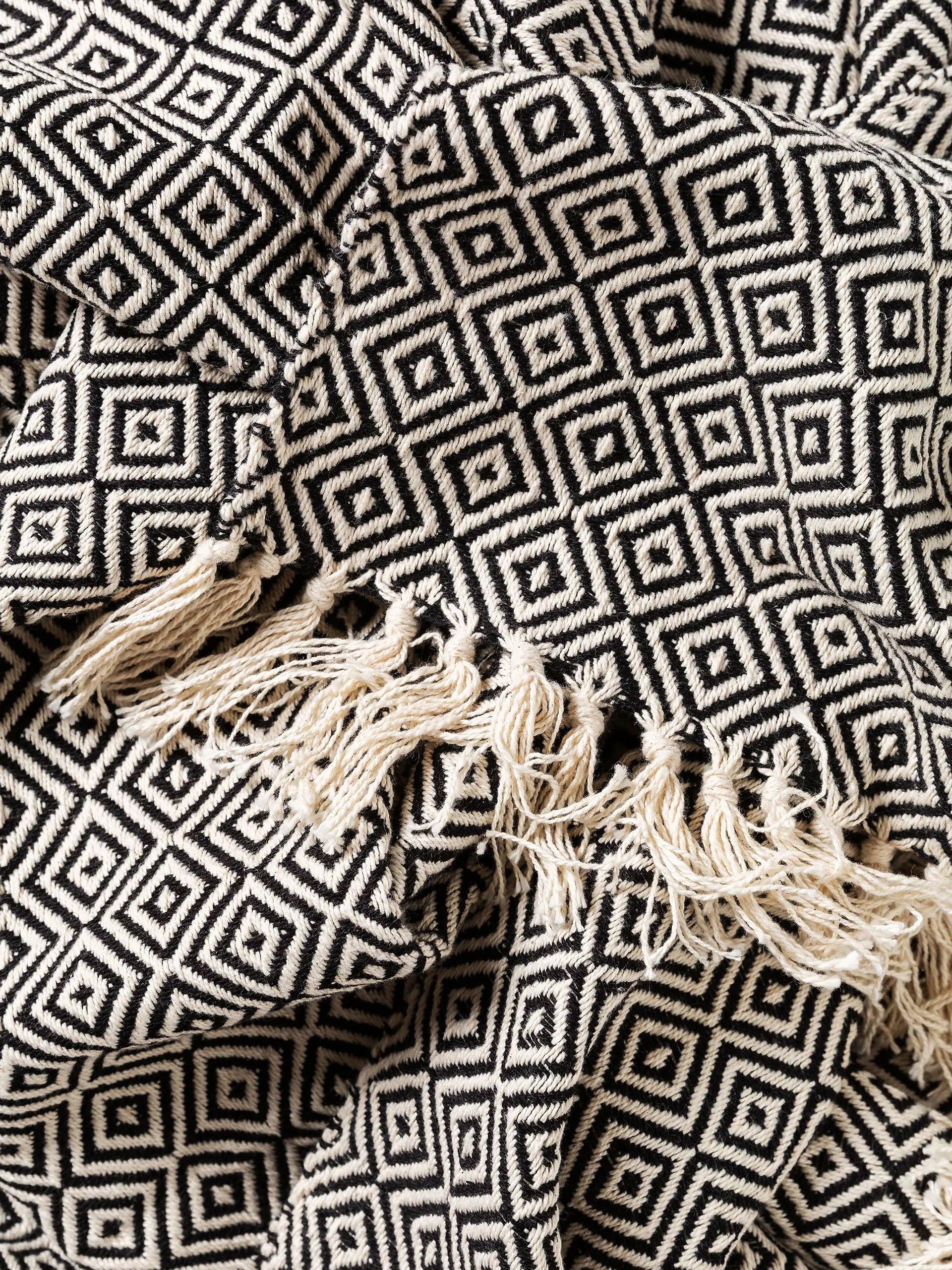 Wunderschöne Karo-Muster auf der schwarzen Jamsin Baumwolldecke von Benuta | Jetzt kaufen bei Wildnest Glamping